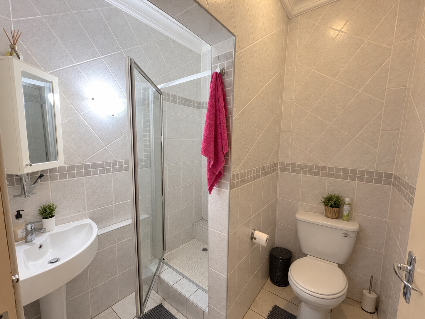 Tidy Tiled Bathroom with Pink Towel 3 Bedroom Apartment Uvongo Beach